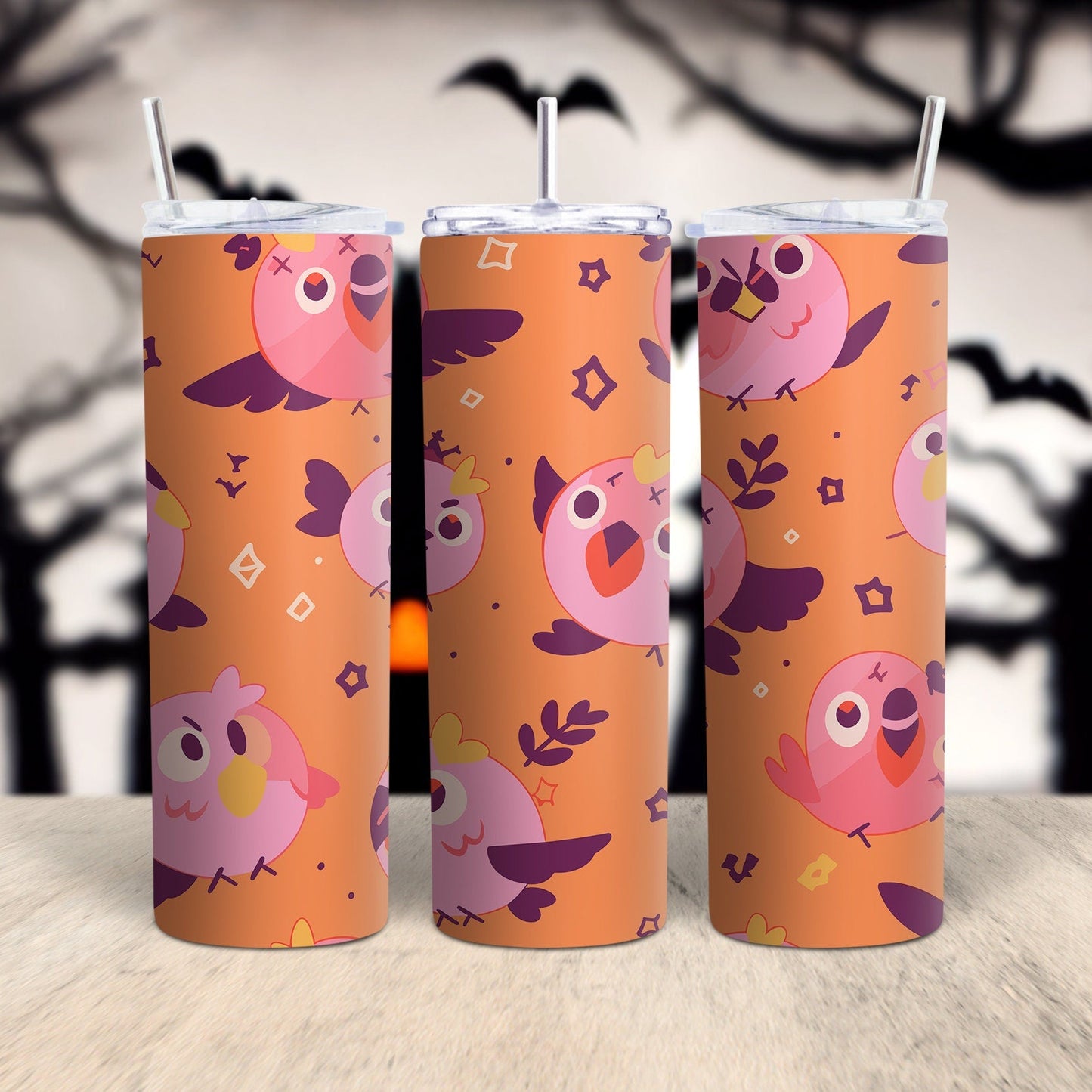 A digital image showing a set of three tumbler wraps with a Halloween-themed design featuring pink and orange colors and various cartoon birds with angry eyes.
